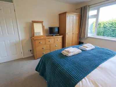 a bedroom with a bed with two towels on it at Fairfell in Keswick