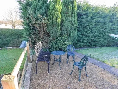 three chairs and a table in a garden at Fairfell in Keswick
