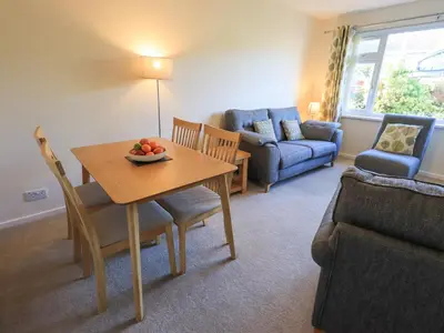 a living room with a table with a bowl of fruit on it at Fairfell in Keswick