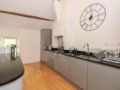 a kitchen with a large clock on the wall at Low Melbecks House in Keswick