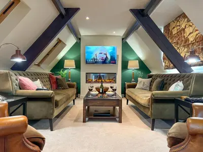 a living room with two couches and a fireplace at Geltsdale East Wing sleeps 6 with River Eden views near Carlisle & Ullswater in Wetheral