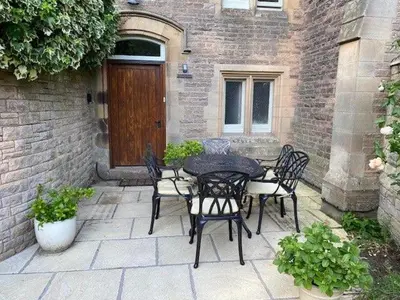 a patio with a table and chairs and a door at Geltsdale East Wing sleeps 6 with River Eden views near Carlisle & Ullswater in Wetheral