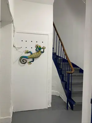 a lizard on a wall next to a staircase at Stylish 2nd Floor Georgian Period Flat in Dumfries
