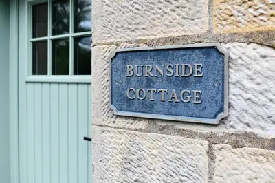 a sign on the side of a building with the words brunswick coffee at Cloncaird Castle Estate Cottages in Maybole