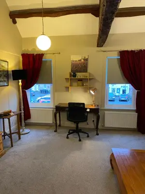 an office with a desk and a chair and two windows at Kezbah 1, 22 the square centre of Dalston village in Dalston