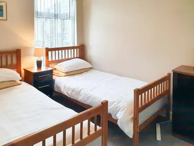 a bedroom with two beds and a window at Apple Cross in Keswick