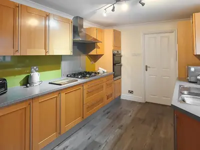 a kitchen with wooden cabinets and a counter top at Apple Cross in Keswick