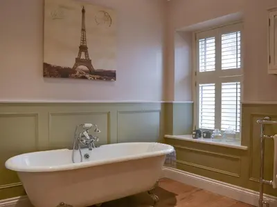 a bath tub in a bathroom with the eiffel tower at Rowan House in Threlkeld