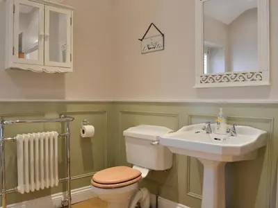 a bathroom with a toilet and a sink at Rowan House in Threlkeld