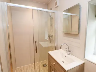 a bathroom with a shower and a sink at Tight Lyne Cottage in Carlisle