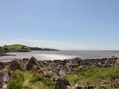 a view of the ocean from a rocky beach at The Barn in Dalbeattie