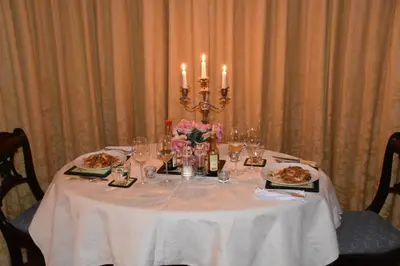 a table with plates of food and candles on it at Applegarth House in Lockerbie