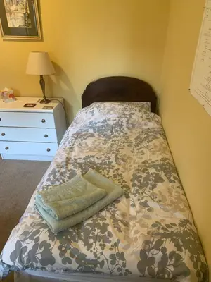 a bed in a room with a dresser and a bed sidx sidx at The Clan Boyd Room in Kilmarnock