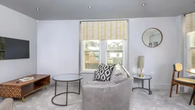 a living room with a couch and a table at Keswick Lake Road Apartments in Keswick