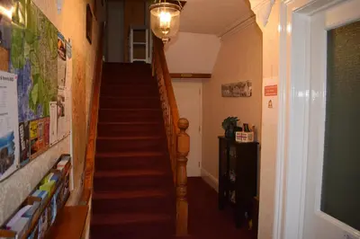 a hallway with a stairway with a stair case at Cragside Guest House in Keswick