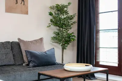 a living room with a couch and a table at Elliot Suite No7 - Donnini Apartments in Ayr