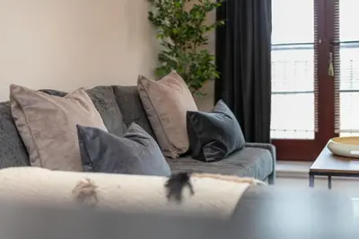 a living room with a couch with pillows at Elliot Suite No7 - Donnini Apartments in Ayr