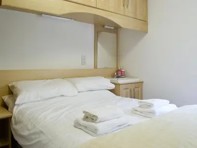 a bedroom with two beds with towels on them at The Old Schoolhouse in Colfin