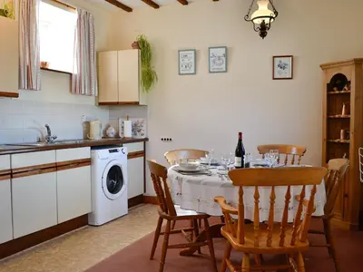 a kitchen with a table with chairs and a sink at Owls Retreat in Whitehaven