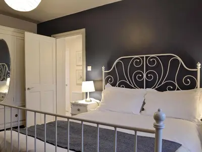 a bedroom with a bed with a black wall at Riverholme in Bassenthwaite