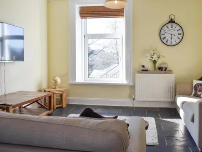 a living room with a couch and a window at Lake Road Heights in Keswick