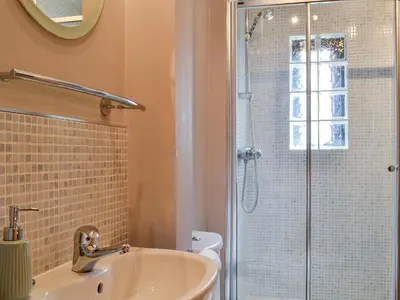 a bathroom with a sink and a shower at River View in Dumfries