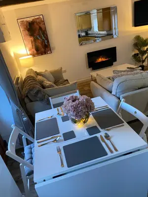 a living room with a table and a couch at The Bothey in Brampton