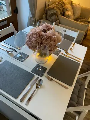 a table with wine glasses and a bowl of flowers on it at The Bothey in Brampton