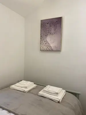 a bedroom with a bed with a picture on the wall at The Bothey in Brampton