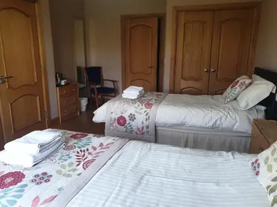 a hotel room with two beds with towels on them at Bamflatt Farm Bed & Breakfast in Strathaven