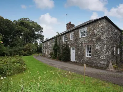 an old stone house on a dirt road at Shore Cottage - Uk12524 in Garlieston