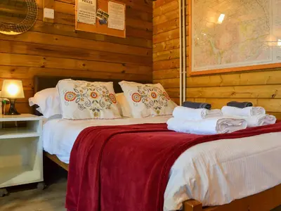 a bedroom with a bed with towels on it at Robin's Lodge in Westward