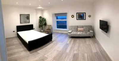a bedroom with a bed and a couch at Maryport House in Maryport