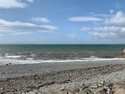 a rocky beach with the ocean in the background at Saltlife Cottage in Port William