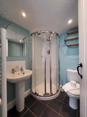 a bathroom with a shower and a sink and a toilet at Juniper HAYLOFT Grasmere in Ambleside