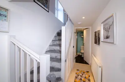 a staircase in a home with white walls at Juniper HAYLOFT Grasmere in Ambleside