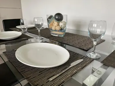 a table with a white plate and wine glasses at Ritson Wharf in Maryport