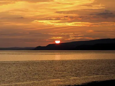 a sunset over a body of water at Killantrae Burn in Port William