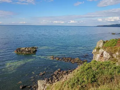 a large body of water with rocks in it at Meadowbank in Girvan