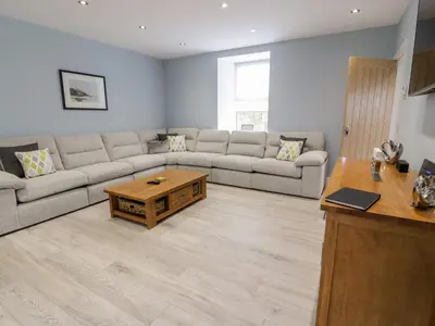 a living room with a couch and a coffee table at Meadowbank in Girvan