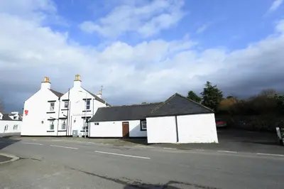 a white house on the side of a street at Star Hotel in Kirkcudbright