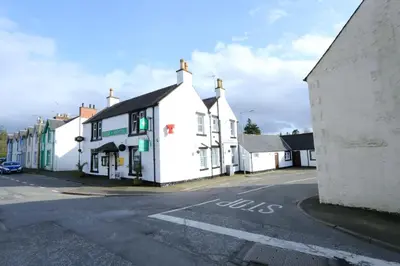 a row of white buildings on a street at Star Hotel in Kirkcudbright