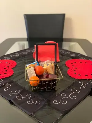 a cake with a basket of fruit on a table at Flat 18 in Dumfries