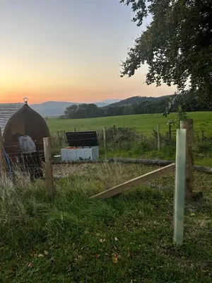 a yurt in a field with a fence and a field at Annabelle's Den in Gatehouse of Fleet