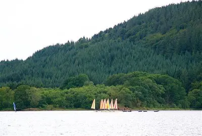 a group of sailboats on a lake with a mountain at Annabelle's Den in Gatehouse of Fleet
