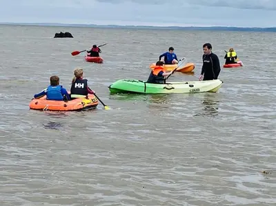 a group of people in kayaks in the water at Beth's Bothy in Gatehouse of Fleet