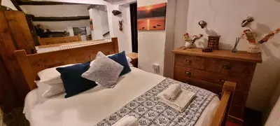 a bedroom with a bed with blue pillows and a mirror at The Big 