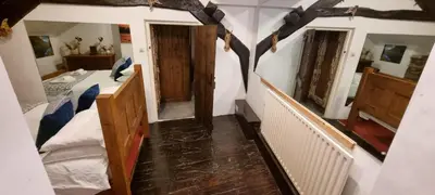 a room with a bedroom with a bed and two mirrors at The Big 