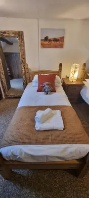 a bedroom with a bed with towels on it at The Big 