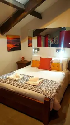a bedroom with a large bed with towels on it at The Big 